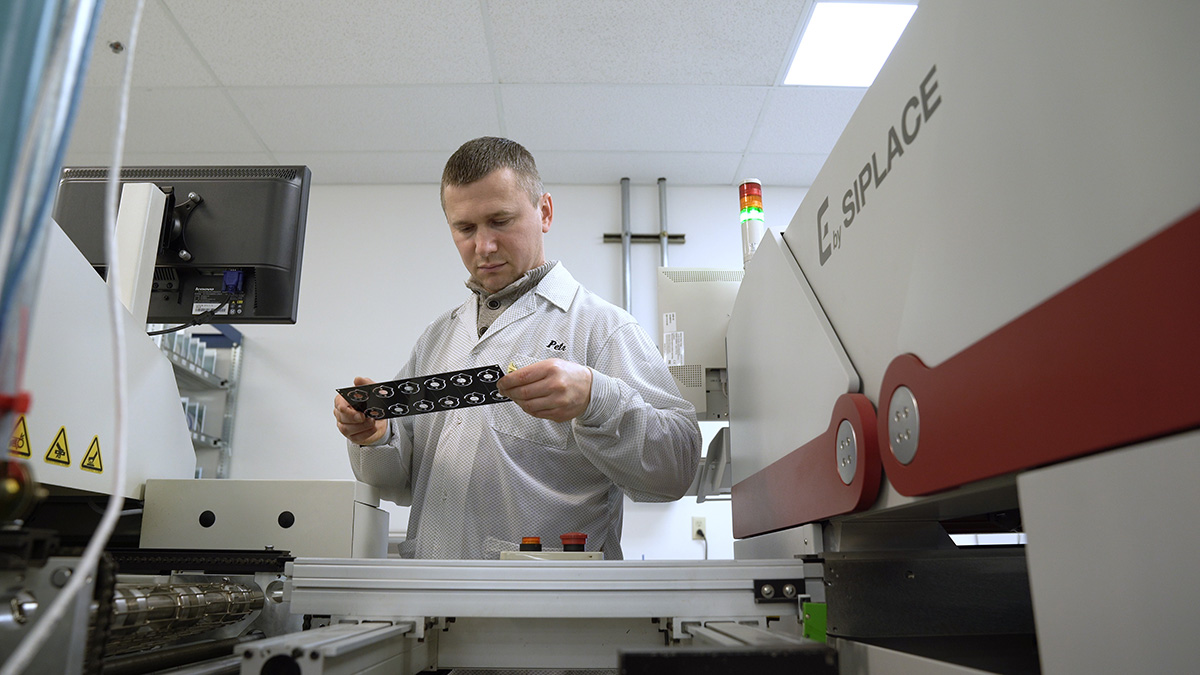 US Digital Soldering Technician Peter Semenov inspects PCBs